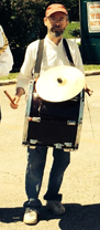 Terran playing a tupan with a cymbal mounted on top.